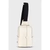 White crossbody bag with a textile strap