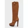 Brown suede boots with gold buckles