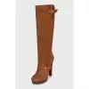 Brown suede boots with gold buckles