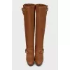 Brown suede boots with gold buckles