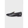 Black leather loafers with gold hardware