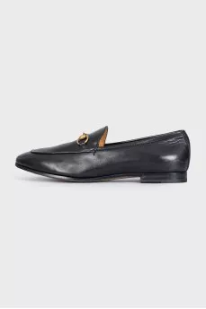Black leather loafers with gold hardware