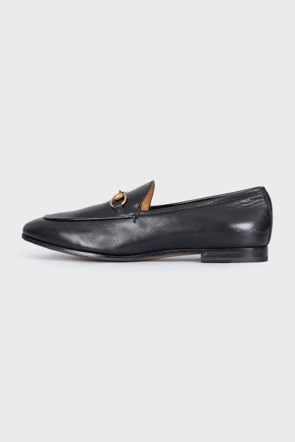 Black leather loafers with gold hardware
