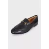 Black leather loafers with gold hardware