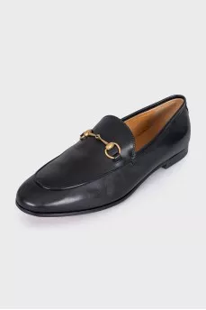Black leather loafers with gold hardware