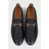 Black leather loafers with gold hardware