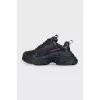 Black sneakers with contrasting Triple S logo