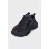 Black sneakers with contrasting Triple S logo