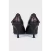 Black leather shoes with a button