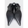 Black leather shoes with a button
