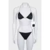 Black swimsuit with branded logo and tag