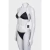 Black swimsuit with branded logo and tag
