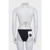 Black swimsuit with branded logo and tag