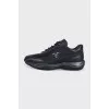 Black sneakers with a brand logo