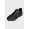 Black sneakers with a brand logo