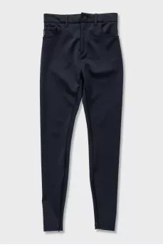 Black tapered trousers with zippers on the trousers