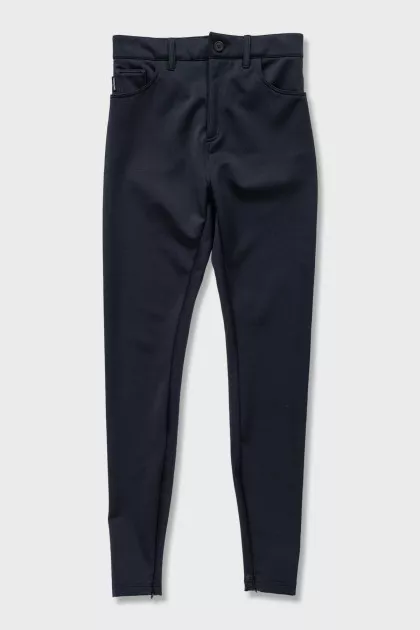 Black tapered trousers with zippers on the trousers