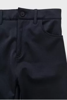 Black tapered trousers with zippers on the trousers