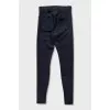 Black tapered trousers with zippers on the trousers