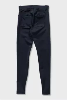 Black tapered trousers with zippers on the trousers