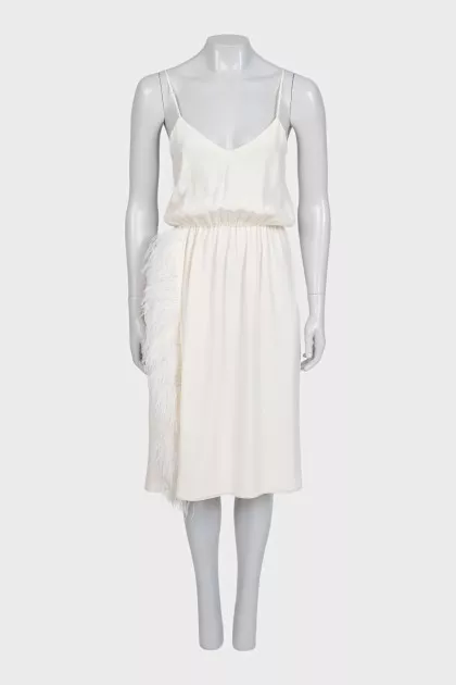 White dress with a cutout decorated with feathers