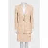 Beige tweed suit with a checkered print skirt