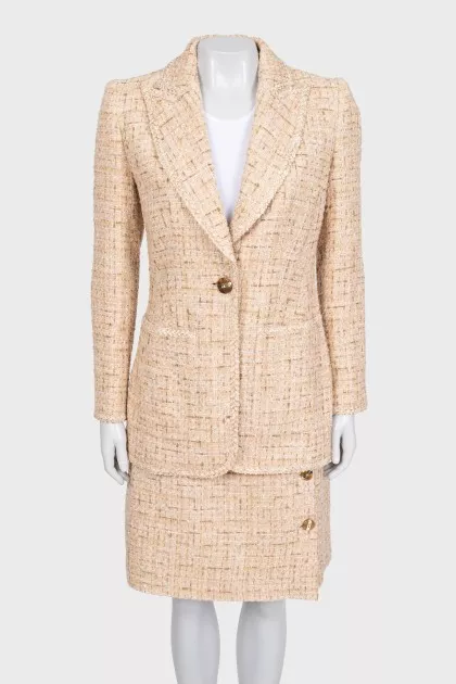 Beige tweed suit with a checkered print skirt