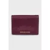 Leather wallet with a button and a brand logo