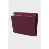 Leather wallet with a button and a brand logo