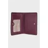 Leather wallet with a button and a brand logo