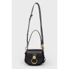 A handbag with a long Tess handle