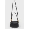 A handbag with a long Tess handle