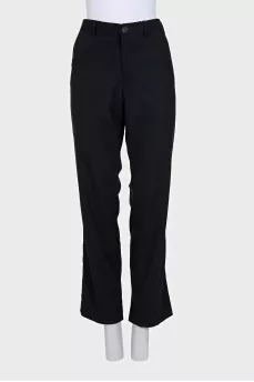 Black wool trousers with a zipper and buttons
