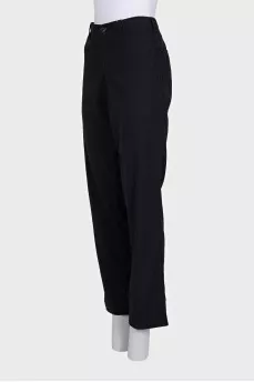 Black wool trousers with a zipper and buttons