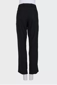 Black wool trousers with a zipper and buttons