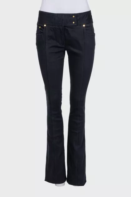Black flared jeans with gold hardware