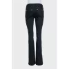 Black flared jeans with gold hardware
