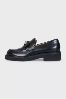 Black loafers with gold hardware