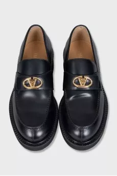 Black loafers with gold hardware
