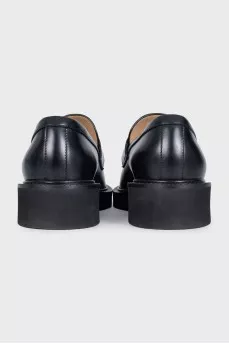 Black loafers with gold hardware