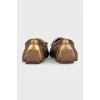 Golden leather moccasins