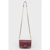 Handbag with a long chain handle