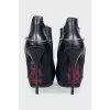 Black leather ankle boots with stiletto heels and no fastening