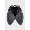 Black leather ankle boots with stiletto heels and no fastening