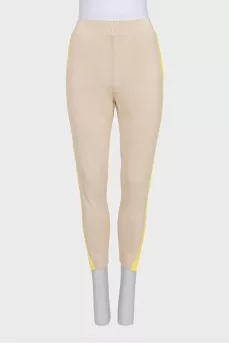 A suit consisting of a jumper with slits and trousers