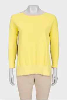 A suit consisting of a jumper with slits and trousers
