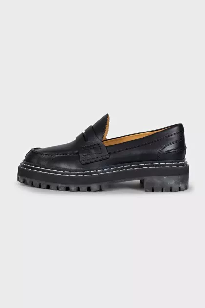 Black leather loafers with white stitching