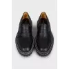Black leather loafers with white stitching