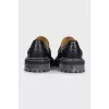 Black leather loafers with white stitching
