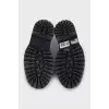 Black leather loafers with white stitching
